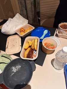 Takeout on the table - wagyu with potato wedges and stew
